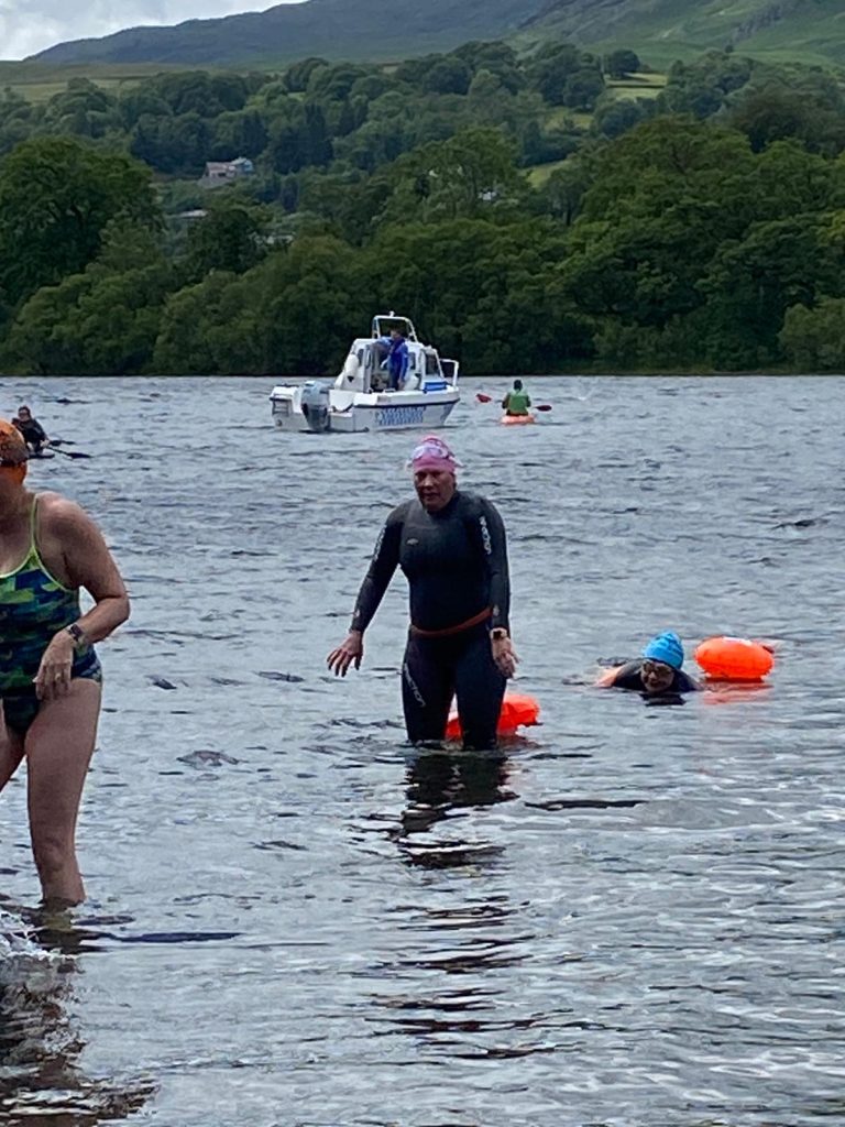 Lou is exiting the water after her 5.25mile swim wearing a wetsuit