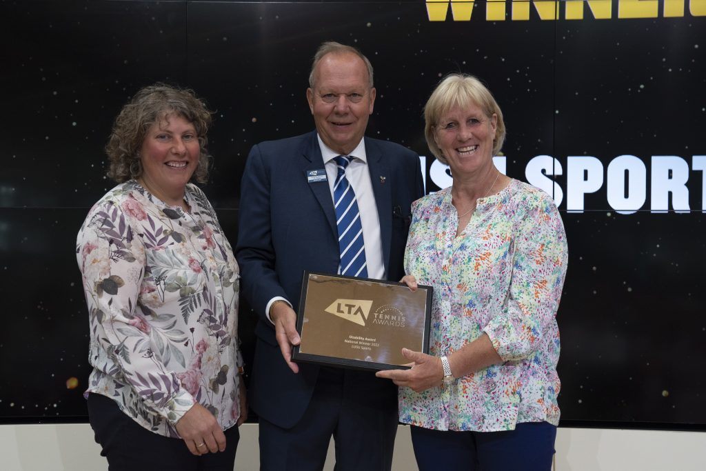 Lou and Sue receiving the National Award from the LTA President David Rawlinson