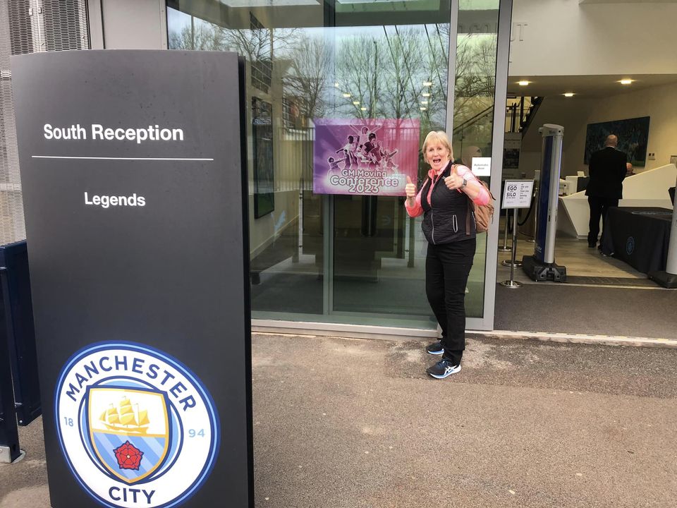 Sue standing outside Manchester City entering the GM Moving Conference